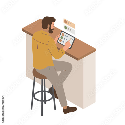 A man sits on a stool at a counter looking at a tablet.