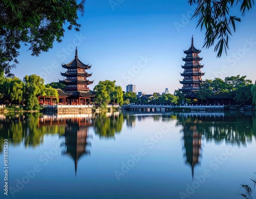 The iconic West Lake's pagodas are beautifully reflected in the calm waters, framed by lush greenery, creating a serene and picturesque scene.