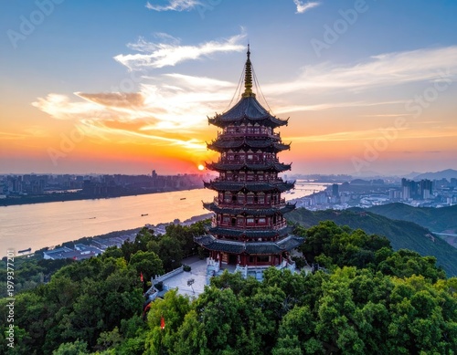 The iconic Wild Goose Pagoda stands majestically against a vibrant sunset over the cityscape and river in Xi'an, China, showcasing a blend of historical architecture and modern urban development.