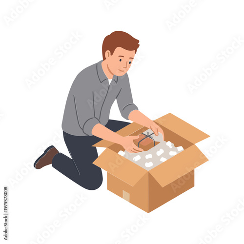 Man kneeling opens cardboard box filled with wrapped items indoors
