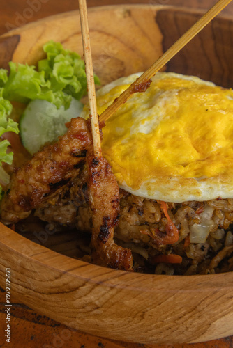 Authentic Indonesian Nasi Goreng fried rice with chicken satay and fried egg