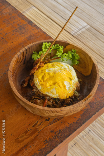 Authentic Indonesian Nasi Goreng fried rice with chicken satay and fried egg