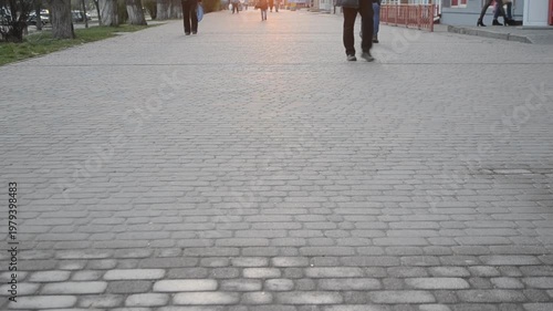 Man in airtight suit sprays disinfecting liquid chemicals antiseptic on street in city on day. Sanitation workers clean pavement, crosswalk. Sanitary measures in public place. Coronavirus pandemic
