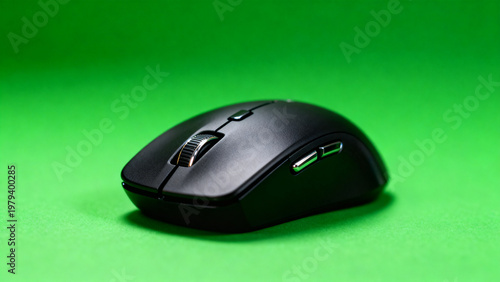 Black wireless computer mouse isolated on green chroma key background with soft studio light, front three quarter product view, office tech and productivity concept, clean stock reference image