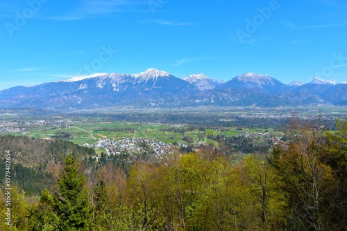 Panoramic view of plains and Karavanke mountains above in Gorenjska, Slovenia in spring