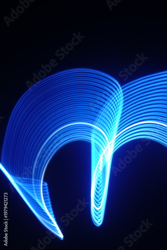 Electric blue light trails against a deep black background