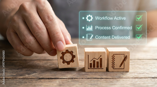 Hand positioning wooden blocks with workflow icons on a table representing business process management and strategy