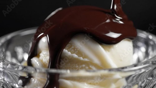 Rich Dark Chocolate Sauce Pouring Over a Scoop of Vanilla Ice Cream