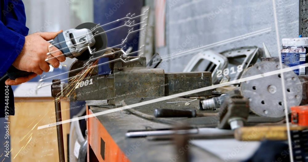 Obraz premium Grinding worker's hands in blue jacket using angle grinder on metal in workshop vise, sparks flying