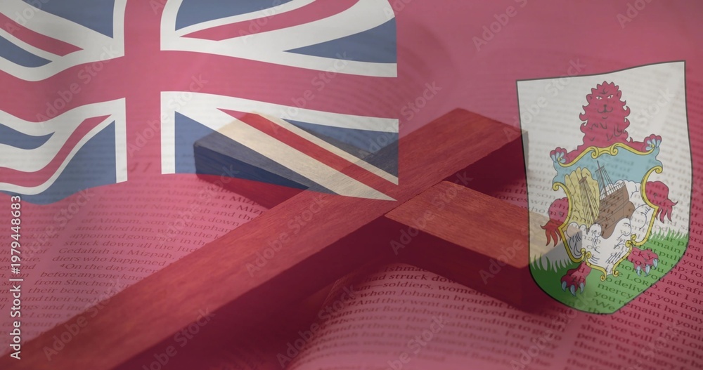 Fototapeta premium Displaying wooden cross resting across open book on table, with Bermuda flag showing Union Jack