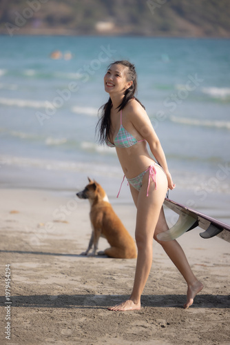 Photography Woman in a bright bikini surfing by the sea, enjoying fun and energetic ocean waves