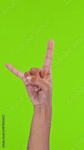 Hand form rock gesture for a bold, playful photo with vibrant green background, showcasing hands and wrist motion and dynamic composition suitable for advertising, social media, and creative projects