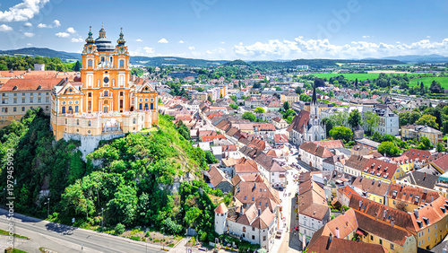 Melk abbey on Danube river in front of the foothills of the Alps on the horizon in the Wachau region in Upper Austria, Austria