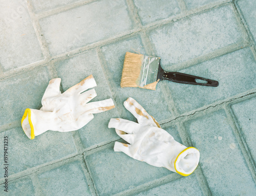 Wallpaper Mural White gloves and paintbrush lie on tiled ground Torontodigital.ca