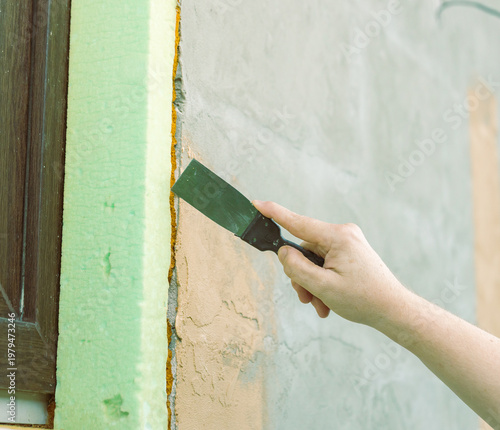 Wallpaper Mural Hand guides scraper along textured wall seam Torontodigital.ca