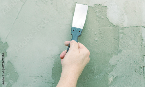 Wallpaper Mural Hand smooths fresh plaster with a putty knife Torontodigital.ca