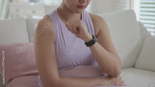 Wrist wear smart watch ECG heart rate stress level warning internet of things risk detect AI app support system. Save life online home IOT chest pain alert health care gadget asia people young woman.