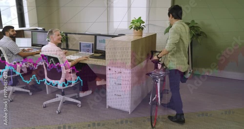 Diverse coworkers greeting colleague pushing road bicycle at office with helmet and bag, copy space