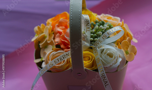 Beautiful floral arrangement of yellow and cream roses in a gift box with 