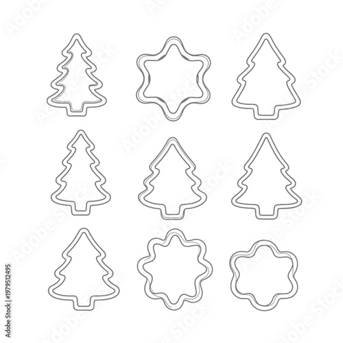 Cookie cutters shaped like Christmas trees and snowflakes are arranged in a neat grid on a plain white background for holiday baking preparation and festive kitchen crafts.