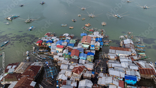 Fishing boats and stilt houses over the water in Bohol, Philippines