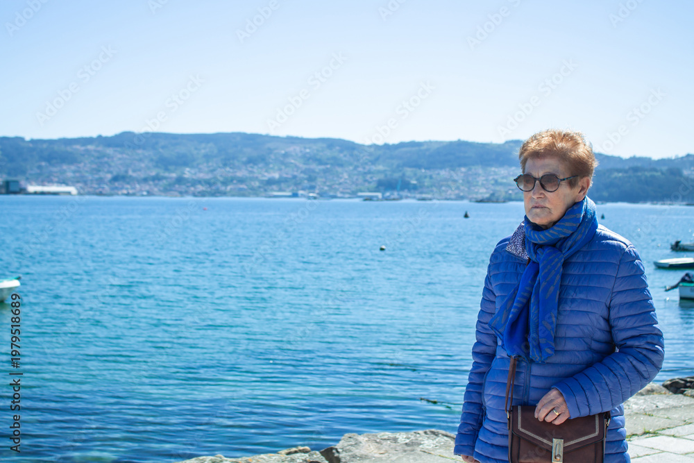 Fototapeta premium senior woman walking along the seafront