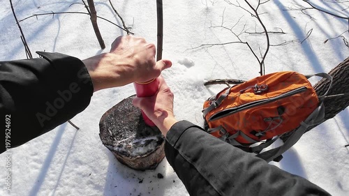 Outdoor Warmth Enjoyed. Hiker Sips Steaming Beverage Outside. Enjoying Hot Drink Beneath Clear Sky While Hiking In Nature. Hiker Relaxes Outdoors With Warm Beverage In Hand During Peaceful Day