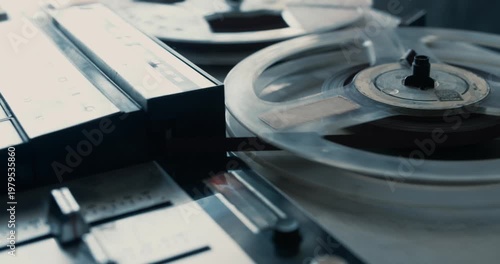 Close-up of a vintage tape recorder playing an old tape on a table