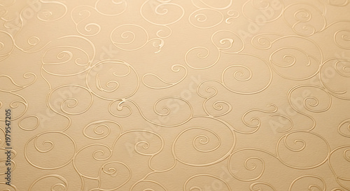 A close-up view of a beige wallpaper with a swirling pattern