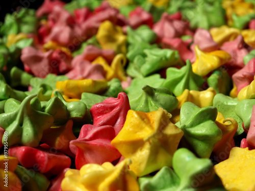 Colorful meringue candies arranged in a pattern at a local market during the afternoon hours