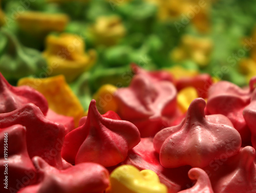 Colorful meringues placed together in a dessert display for a party or festive event in a bakery or kitchen