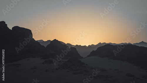 Photography night desert landscape with rocky mountains and sunset sky with clouds in Egypt