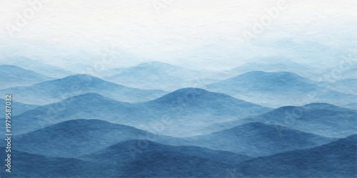 A scenic morning view of a misty blue sky with clouds over a sunlit mountain landscape featuring snow capped hills and a fog covered forest valley at sunrise
