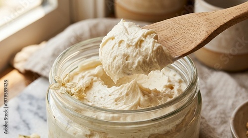 Whipped Shea Body Butter Scooped with Wooden Spatula from Wide Jar