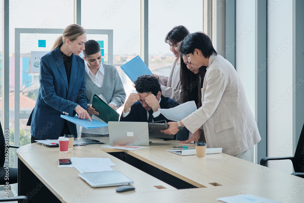 Obraz premium Male company boss is overwhelmed with marketing coworkers, busy document work decisions, stress, and burnout from leader task pressure, meetings at business firm, and multiracial corporate people.