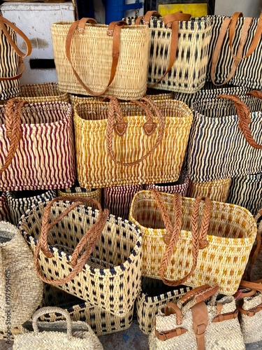 Colorful straw bags sold in street market in  in Marrakech, Morocco .