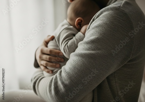 Father holding his newborn baby close, tender moment of love and care.