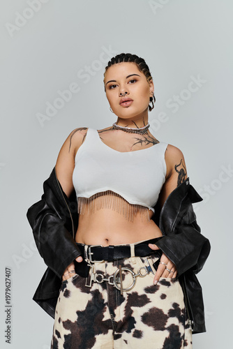 Stylish young woman showcasing bold fashion in a minimalist studio setting