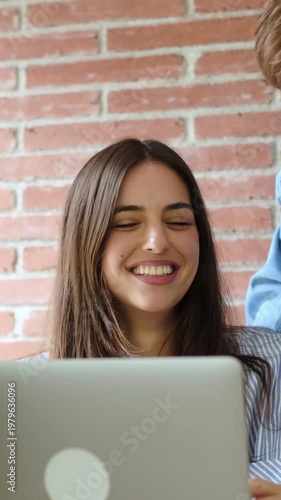 Young Couple Collaborating and Smiling While Working on a Laptop at Home