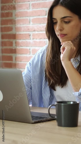 Young Woman Focused on Laptop Work from Home, Typing and Thinking at Her Desk