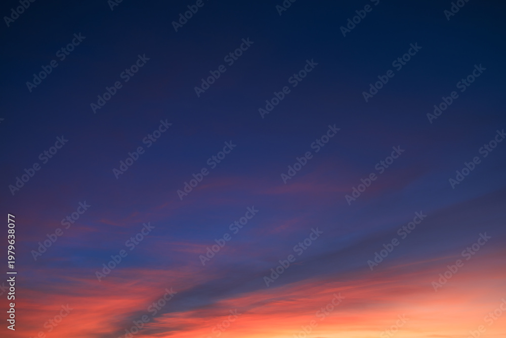Fototapeta premium Bright orange and blue colored clouds on evening sky