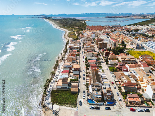 Aerial view of Lo Pagan cityscape with seafront promenade and salt lakes mud baths natural, open-air health spa, located on the northern edge of the Mar Menor, in Murcia, Spain 