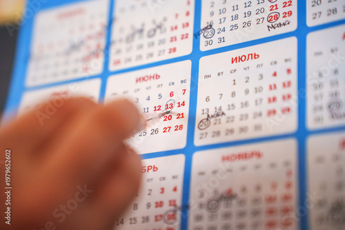 Marking dates on a wall calendar for upcoming events