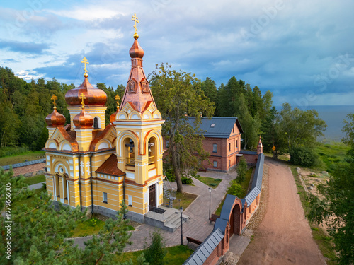 Tableau sur toile Aerial view of Russian Orthodox Skete with red brick architecture, Lake Ladoga shore, Konevets Island, Leningrad Region