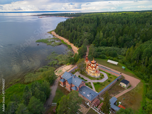 Tableau sur toile Aerial view of Russian Orthodox Skete with red brick architecture, Lake Ladoga shore, Konevets Island, Leningrad Region