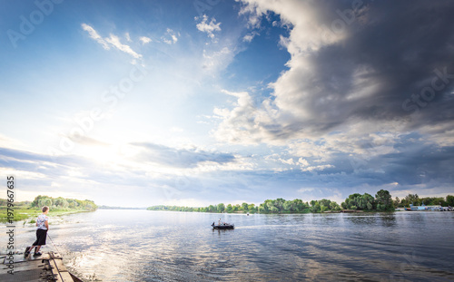 Wallpaper Mural Solemn fisherman stands by calm waters Torontodigital.ca
