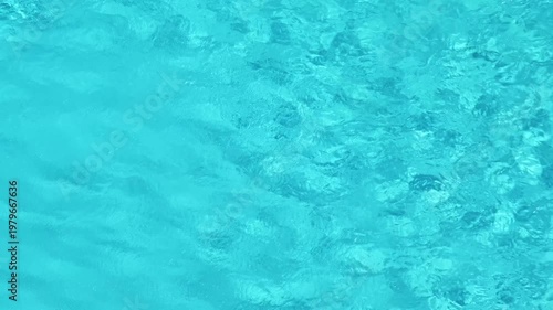 waves of water on surface of swimming pool with blue water, close-up, slow motion
