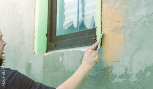 Wallpaper Mural Man points at cracked wall beside green-framed window Torontodigital.ca