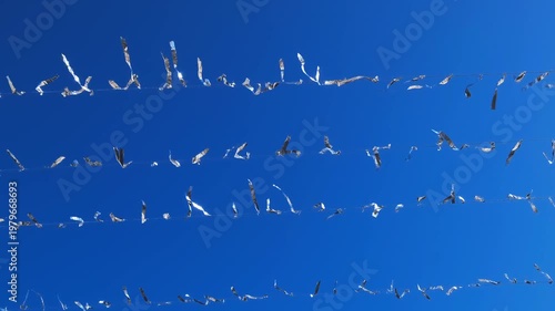silver shiny ribbon festive decorations on ropes, close-up, slow motion
