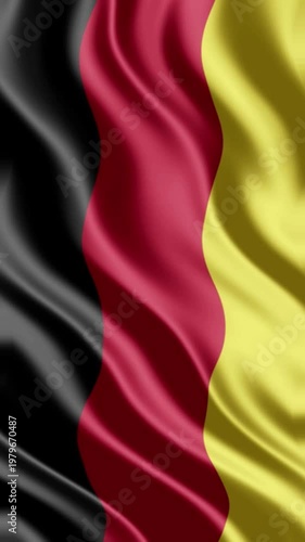 Deep folds in a silk Germany flag background showing realistic black red and gold texture.